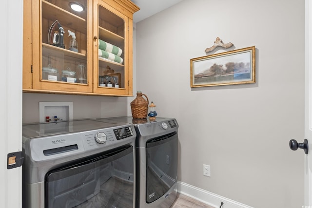 589 Boundaryline Dr NW, Calabash, NC 28467 - laundry area featuring cabinet space, separate washer and dryer, and light wood finished floors