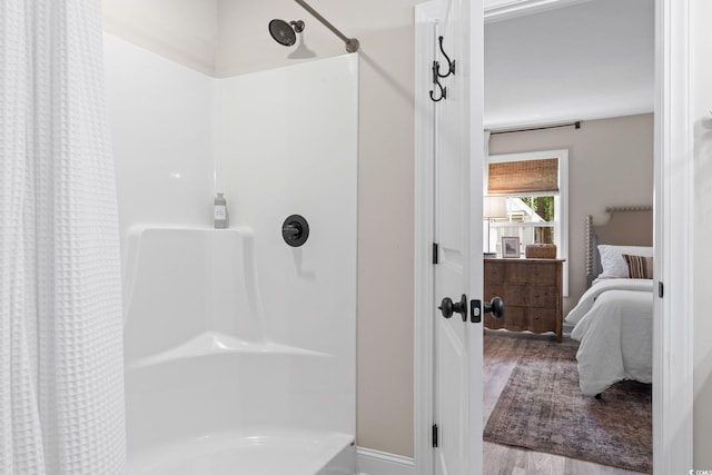 589 Boundaryline Dr NW, Calabash, NC 28467 - full bath with ensuite bathroom, wood finished floors, and shower / tub combo with curtain