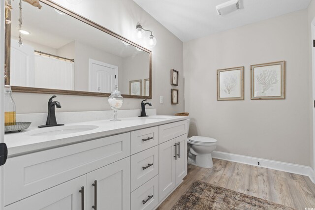 589 Boundaryline Dr NW, Calabash, NC 28467 - bathroom with double vanity and wood finished floors