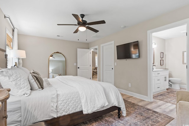 589 Boundaryline Dr NW, Calabash, NC 28467 - bedroom featuring light wood finished floors, ensuite bathroom, and ceiling fan