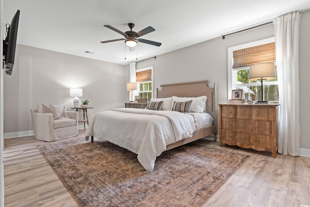 589 Boundaryline Dr NW, Calabash, NC 28467 - bedroom with wood finished floors, multiple windows, and ceiling fan
