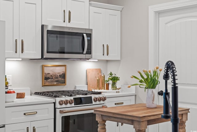 589 Boundaryline Dr NW, Calabash, NC 28467 - kitchen featuring gas range gas stove, stainless steel microwave, white cabinetry, and butcher block countertops