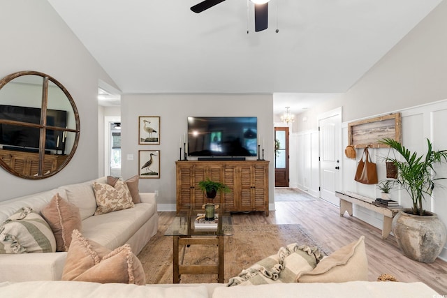 589 Boundaryline Dr NW, Calabash, NC 28467 - living area with lofted ceiling, wood finished floors, a ceiling fan, a chandelier, and healthy amount of natural light