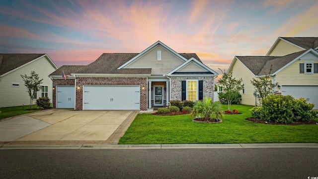 138 Copper Leaf Dr, Myrtle Beach, SC 29588 - traditional home featuring an attached garage, brick siding, a lawn, and driveway