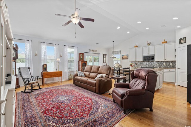 138 Copper Leaf Dr, Myrtle Beach, SC 29588 - living room featuring vaulted ceiling, light wood finished floors, a ceiling fan, recessed lighting, and a chandelier