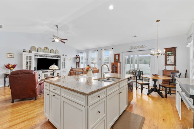 138 Copper Leaf Dr, Myrtle Beach, SC 29588 - kitchen with light wood-style flooring, vaulted ceiling, open floor plan, ceiling fan, and white cabinets