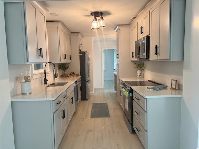 518 Nowell St, Georgetown, SC 29440 - kitchen with appliances with stainless steel finishes, light countertops, and light wood-type flooring