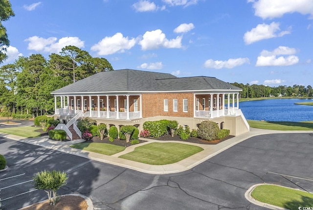 1064 Links Rd, Surfside Beach, SC 29575 - rear view of house with a porch, stairs, a water view, uncovered parking, and a lawn