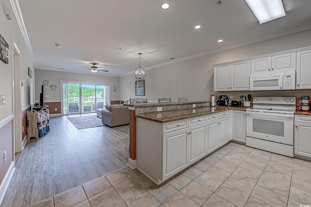 110 S Shore Blvd Unit 203, Longs, SC 29568 - kitchen with white appliances, a peninsula, crown molding, open floor plan, and white cabinetry