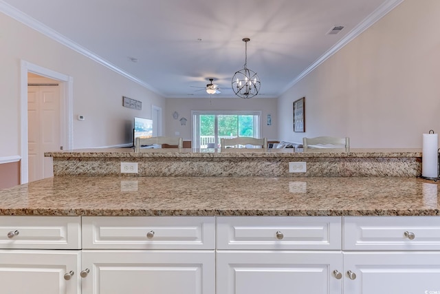 110 S Shore Blvd Unit 203, Longs, SC 29568 - kitchen featuring a chandelier, a ceiling fan, ornamental molding, light stone counters, and white cabinets