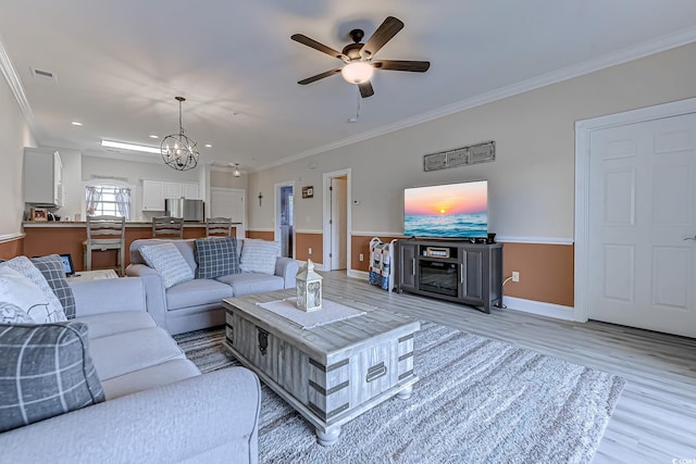 110 S Shore Blvd Unit 203, Longs, SC 29568 - living area with light wood finished floors, crown molding, ceiling fan, a chandelier, and recessed lighting