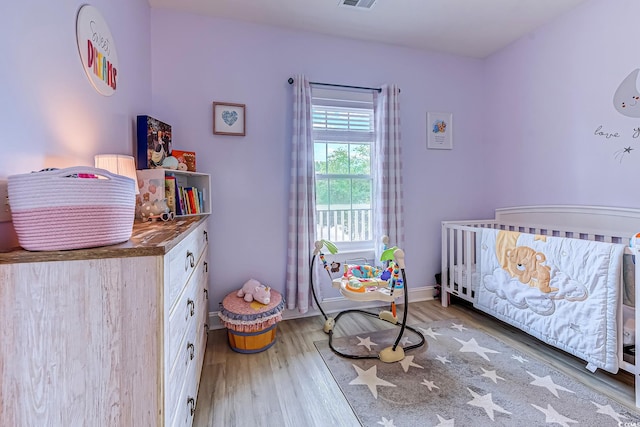 110 S Shore Blvd Unit 203, Longs, SC 29568 - bedroom featuring a crib and wood finished floors