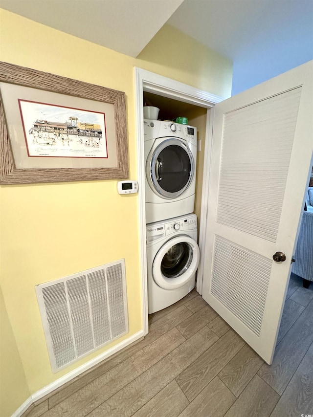 404 29th Ave N, North Myrtle Beach, SC 29582 - washroom with stacked washer / drying machine and wood finished floors