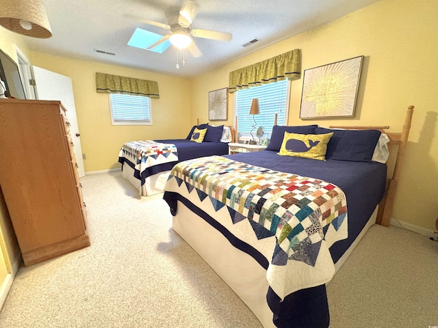 404 29th Ave N, North Myrtle Beach, SC 29582 - bedroom with light carpet, ceiling fan, and a skylight
