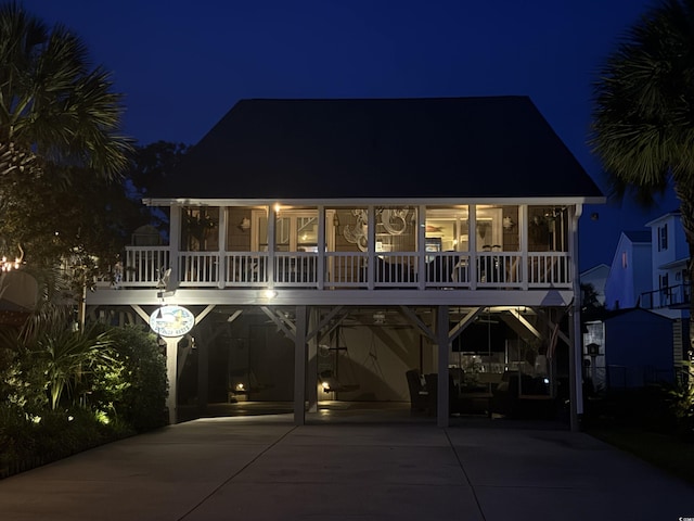 404 29th Ave N, North Myrtle Beach, SC 29582 - view of front facade featuring a carport, driveway, and a sunroom