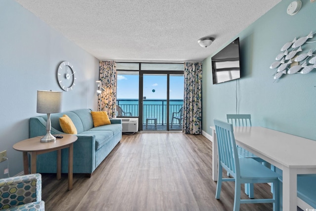 1501 S Ocean Blvd Unit 1039, Myrtle Beach, SC 29577 - living area featuring a textured ceiling, wood finished floors, and floor to ceiling windows