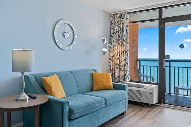 1501 S Ocean Blvd Unit 1039, Myrtle Beach, SC 29577 - living area featuring wood finished floors, a wall of windows, a textured ceiling, and a water view