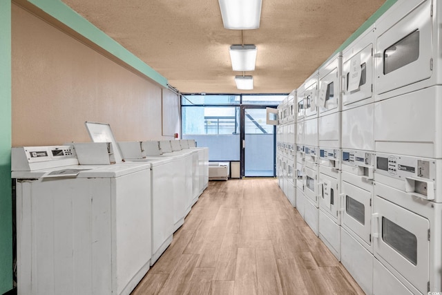 1501 S Ocean Blvd Unit 1039, Myrtle Beach, SC 29577 - community laundry room with stacked washer / drying machine, washing machine and clothes dryer, light wood finished floors, and a textured ceiling