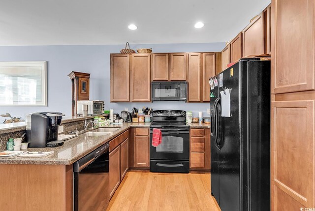 1857 Culbertson Ave Unit 1857, Myrtle Beach, SC 29577 - kitchen with black appliances, light wood-type flooring, a peninsula, light stone countertops, and recessed lighting