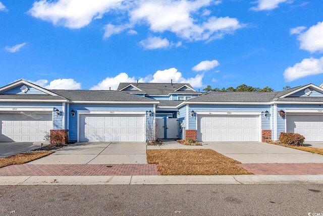 1857 Culbertson Ave Unit 1857, Myrtle Beach, SC 29577 - view of front of house featuring driveway, an attached garage, brick siding, and a gate