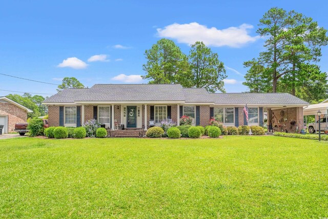 1005 S Main St, Mullins, SC 29574 - ranch-style house featuring covered porch, a front lawn, and brick siding