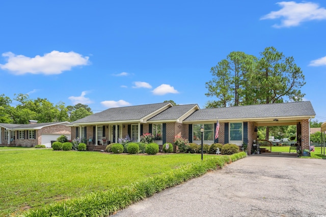 1005 S Main St, Mullins, SC 29574 - ranch-style house featuring driveway, a front yard, brick siding, a carport, and covered porch