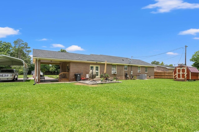 1005 S Main St, Mullins, SC 29574 - back of house featuring a shed, brick siding, a detached carport, and a patio