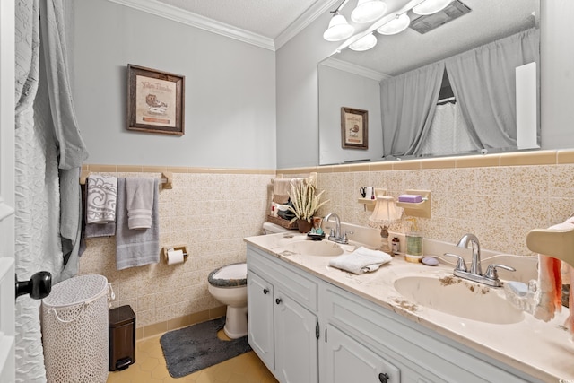 1005 S Main St, Mullins, SC 29574 - bathroom featuring double vanity, crown molding, tile patterned floors, tile walls, and wainscoting