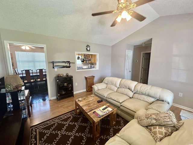 706 Jamie Ln, Conway, SC 29526 - living room with a ceiling fan, wood finished floors, vaulted ceiling, and a textured ceiling