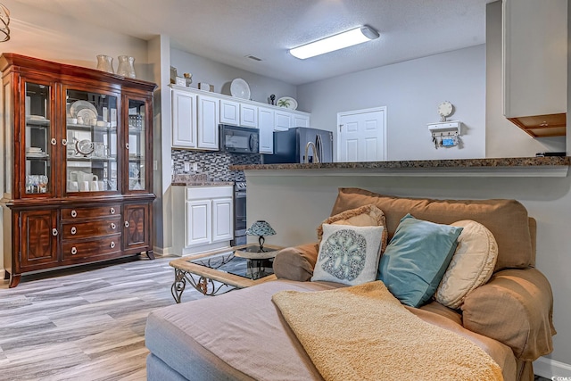 4355 Rivergate Ln Unit F, Little River, SC 29566 - bedroom featuring stainless steel fridge with ice dispenser and light wood-style floors