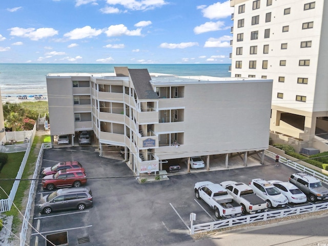 1011 S Ocean Blvd Unit 301, North Myrtle Beach, SC 29582 - view of property featuring uncovered parking and a water view