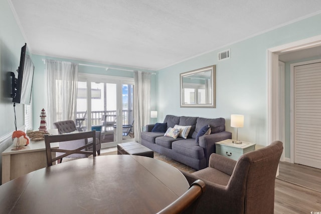 1011 S Ocean Blvd Unit 301, North Myrtle Beach, SC 29582 - living area featuring wood finished floors and crown molding