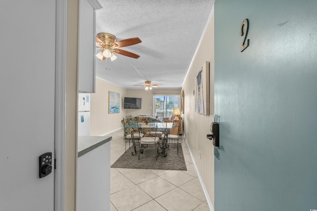 6301 N Ocean Blvd Unit 2B, North Myrtle Beach, SC 29582 - dining room featuring light tile patterned flooring, ceiling fan, and a textured ceiling