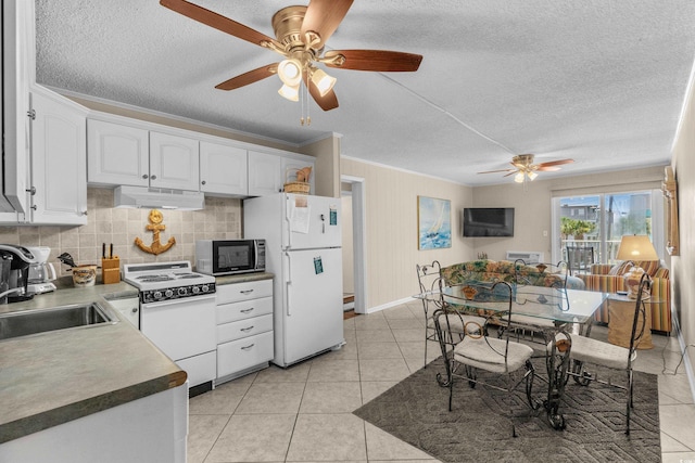 6301 N Ocean Blvd Unit 2B, North Myrtle Beach, SC 29582 - kitchen featuring white appliances, under cabinet range hood, ceiling fan, a textured ceiling, and white cabinetry