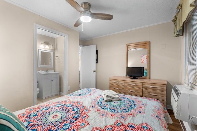 6301 N Ocean Blvd Unit 2B, North Myrtle Beach, SC 29582 - bedroom featuring ornamental molding, ensuite bathroom, ceiling fan, and light wood-style floors