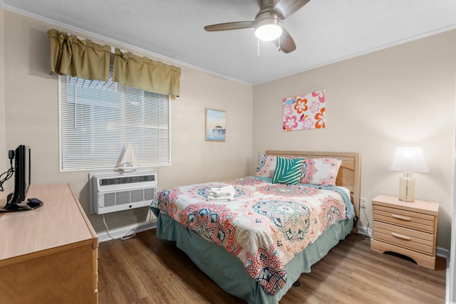6301 N Ocean Blvd Unit 2B, North Myrtle Beach, SC 29582 - bedroom featuring wood finished floors, crown molding, a wall unit AC, and ceiling fan