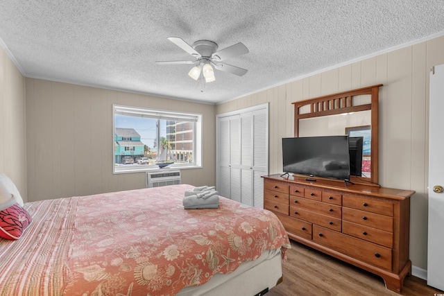 6301 N Ocean Blvd Unit 2B, North Myrtle Beach, SC 29582 - bedroom featuring wood finished floors, ornamental molding, a closet, a textured ceiling, and ceiling fan