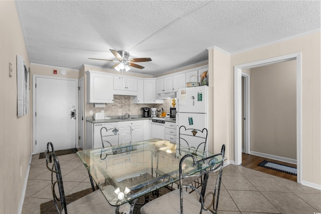 6301 N Ocean Blvd Unit 2B, North Myrtle Beach, SC 29582 - kitchen featuring white appliances, light tile patterned floors, a ceiling fan, under cabinet range hood, and decorative backsplash