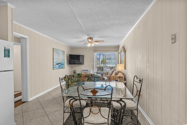 6301 N Ocean Blvd Unit 2B, North Myrtle Beach, SC 29582 - dining space with ceiling fan, light tile patterned floors, crown molding, a textured ceiling, and wood walls