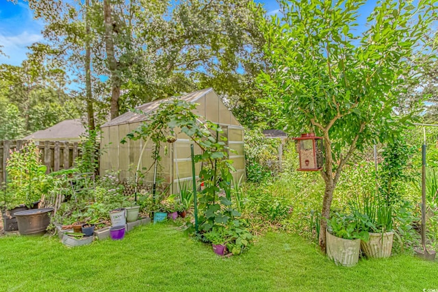 189 Aspen Loop, Pawleys Island, SC 29585 - view of yard featuring a greenhouse, an outdoor structure, and a garden