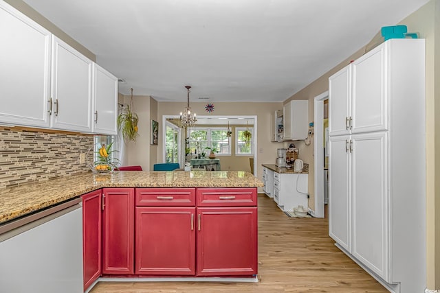 189 Aspen Loop, Pawleys Island, SC 29585 - kitchen with dishwasher, a chandelier, light wood-type flooring, a peninsula, and white cabinets