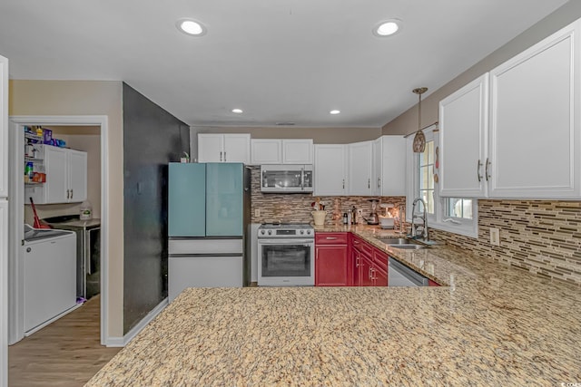 189 Aspen Loop, Pawleys Island, SC 29585 - kitchen featuring stainless steel appliances, washing machine and clothes dryer, light stone counters, white cabinetry, and recessed lighting