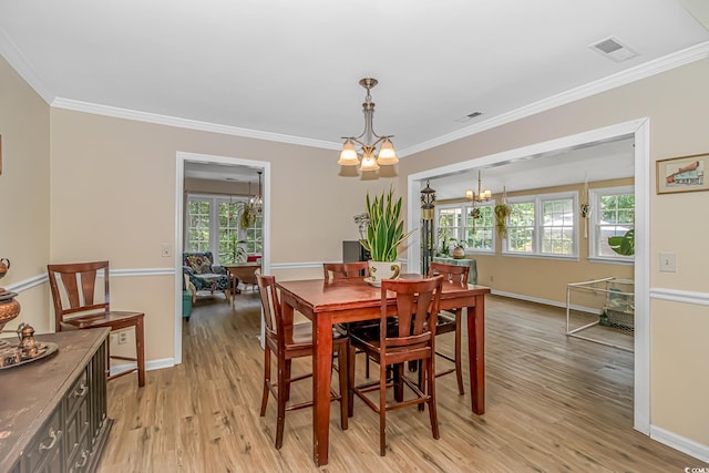 189 Aspen Loop, Pawleys Island, SC 29585 - dining space with a chandelier, healthy amount of natural light, light wood finished floors, and crown molding