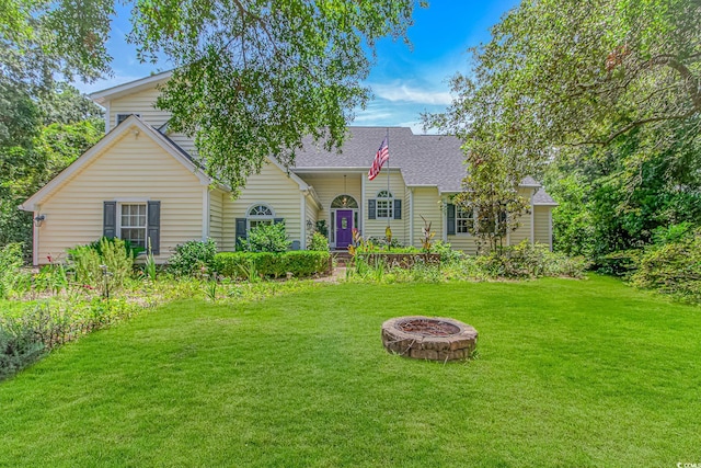 189 Aspen Loop, Pawleys Island, SC 29585 - view of front of property featuring a front yard, an outdoor fire pit, and a shingled roof