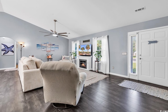 3907 Stillwood Dr, Myrtle Beach, SC 29588 - living room featuring vaulted ceiling, a ceiling fan, dark wood-type flooring, and a glass covered fireplace