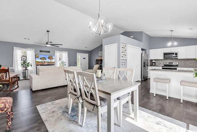 3907 Stillwood Dr, Myrtle Beach, SC 29588 - dining area featuring lofted ceiling, dark wood-type flooring, ceiling fan, and a chandelier