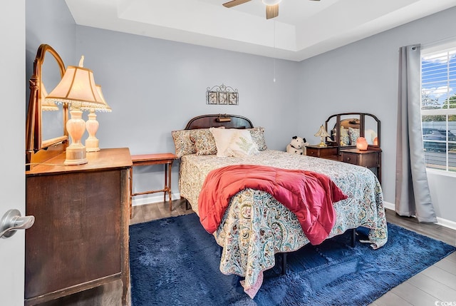 3907 Stillwood Dr, Myrtle Beach, SC 29588 - bedroom with wood finished floors, ceiling fan, and a tray ceiling