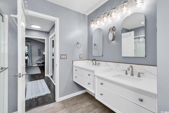 3907 Stillwood Dr, Myrtle Beach, SC 29588 - bathroom with connected bathroom, double vanity, and wood finished floors