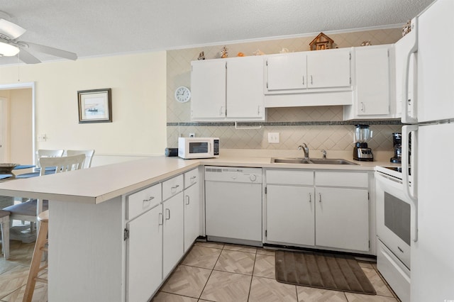 1820 N Ocean Blvd Unit 303D, North Myrtle Beach, SC 29582 - kitchen with white appliances, a peninsula, a textured ceiling, ornamental molding, and light countertops
