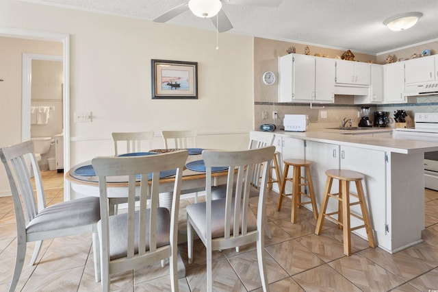 1820 N Ocean Blvd Unit 303D, North Myrtle Beach, SC 29582 - dining room with ceiling fan and a textured ceiling